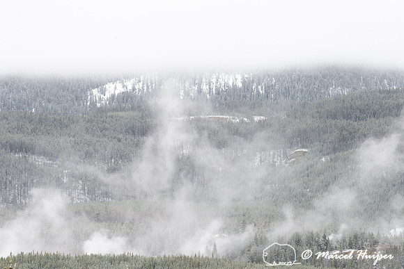 Snow covered forested mountains with clouds, Wyoming, USA
