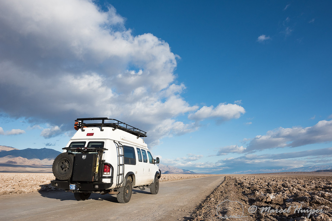 Camper van on dirt road, Devil's golf course, Death Valley Natio