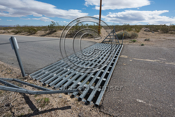 Wildlife and cattle guard at access road in association with fen