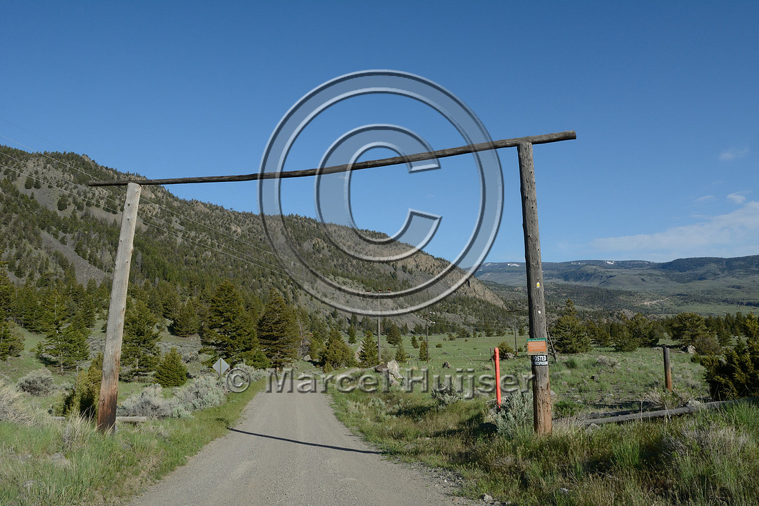 Public road through private lands. This gate and sign mark a a public land / private land boundary along a public road