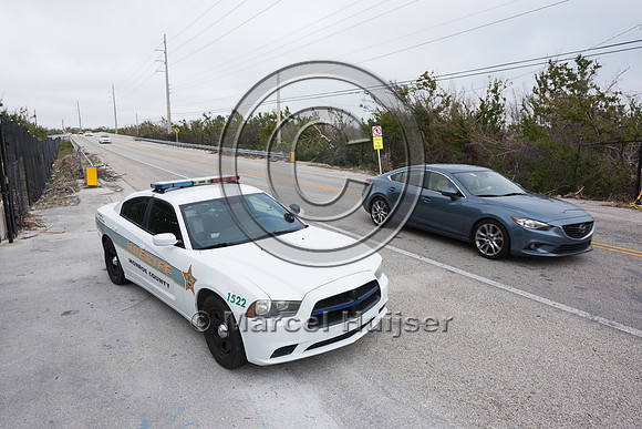 Speed management for Key deer, parked police car, no law enforce