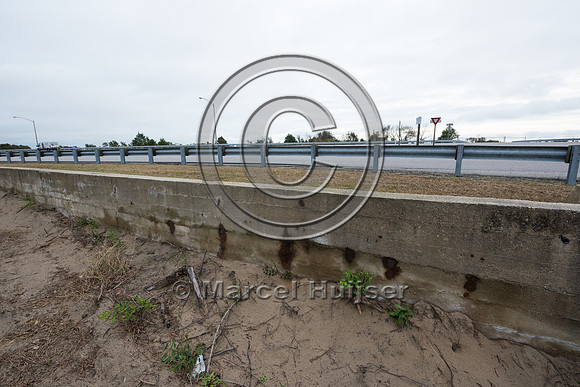 Concrete barrier wall along Hwy 13, Fisherman Island National Wi