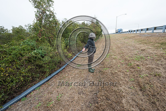 Pamela Denmon demonstrates where the plastic corrugated pipe sho
