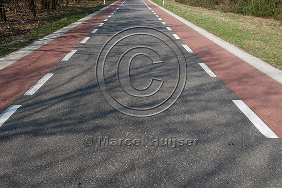 Striping on road with bicycle lanes, visually narrows lane and r