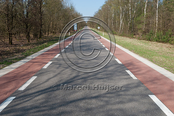 Striping on road with bicycle lanes, visually narrows lane and r