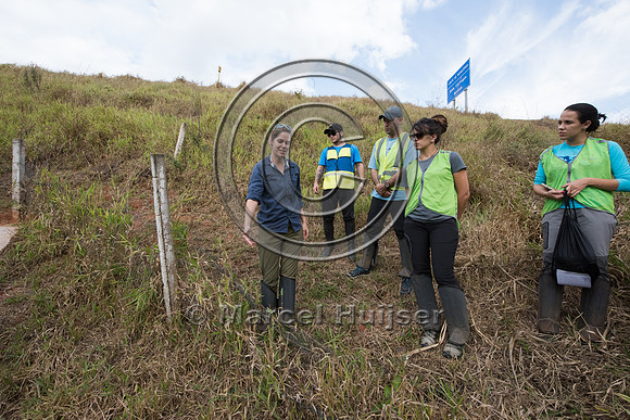 Students at road ecology field course, wildlife fence in disrepa