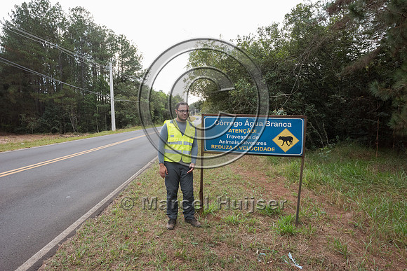 Douglas Cirino at wildlife warning sign for maned wolf, Itirapin