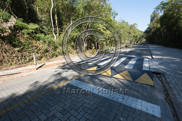 Speed bump and crosswalk at parking area along road, Carlos Bote