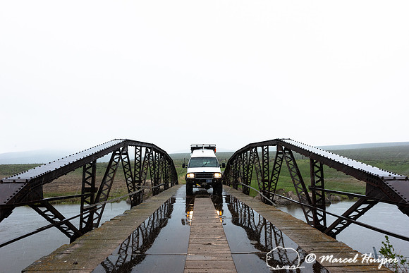 Camper van on bridge across Red Rock River in Centennial Valley,