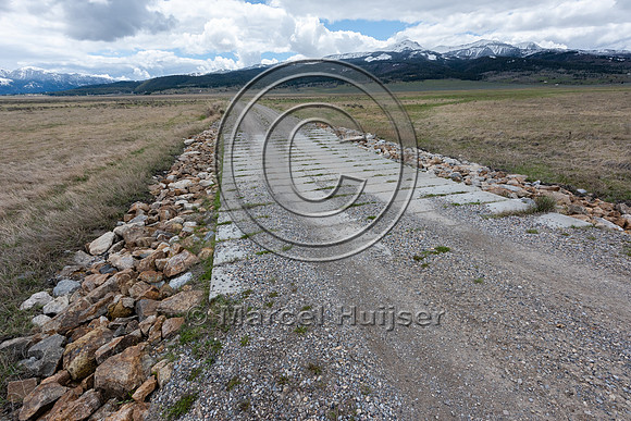 Dip allowing water to flow across road at high water levels, Cen