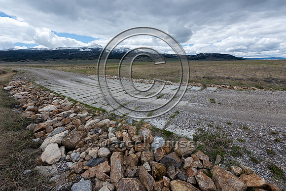 Dip allowing water to flow across road at high water levels, Cen