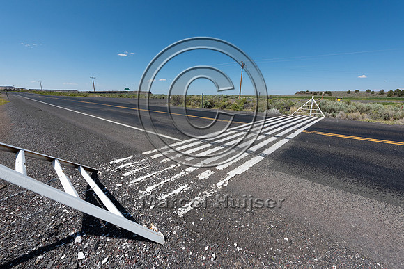 White stripes painted on the road surface meant to imitate a cat