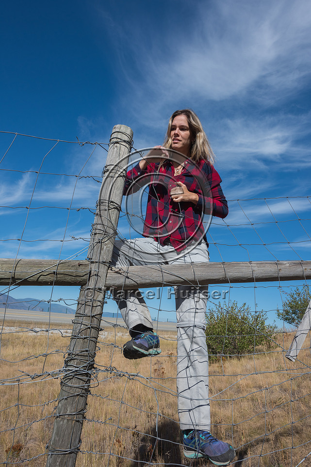 Fernanda Abra climbing a wildlife fence, north of Bonners Ferry,