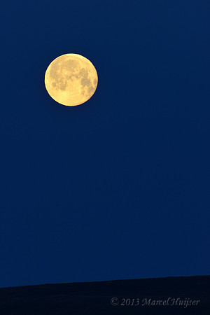 Full moon setting on the horizon, near Bannack, Montana, USA