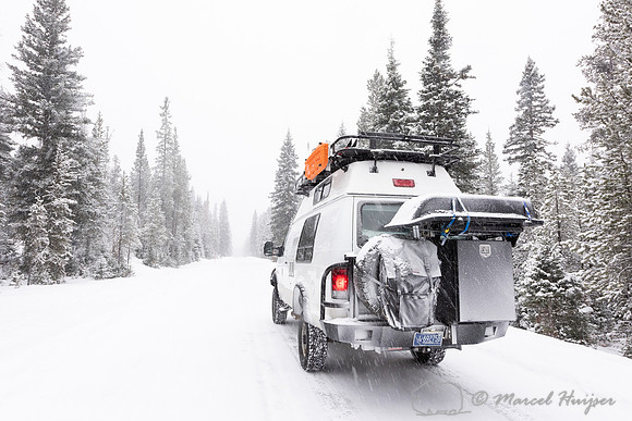 Camper van in snow storm, Wyoming