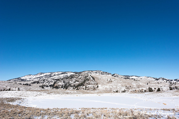 Snowy landscape with lake, Wyoming, USA