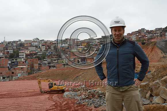 Marcel Huijser at a construction site of the Rodoanel Norte - the northern section of the outer belt way of Greater São Paulo, Brazil. The houses in the background are a favela (slums) that have been