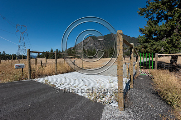 Wildlife guard and gate at access road, to keep wildlife, primar