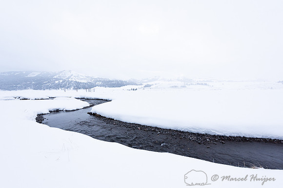 Creek in snowfield, Wyoming