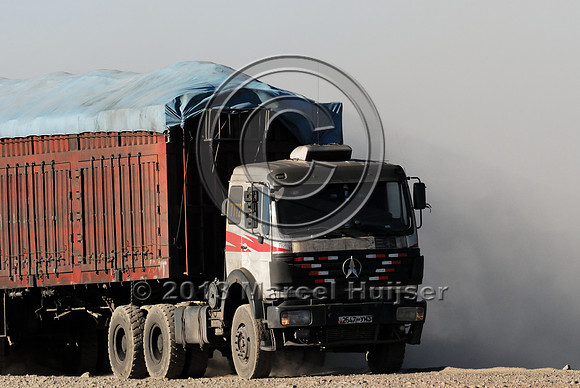 Coal trucks hauling coal to the border and dust, between Tsagaan khad (White Rock) and Gashuun-Sukhait, Gobi, Mongolia