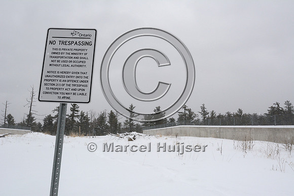 No tresspassing sign at wildlife overpass, Hwy 69, Ontario, Canada