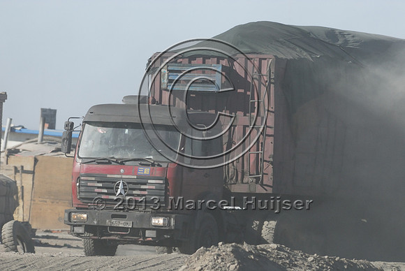 Coal trucks hauling coal to the border and dust, between Tsagaan khad (White Rock) and Gashuun-Sukhait, Gobi, Mongolia