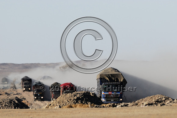 Coal trucks hauling coal to the border and dust, between Tsagaan khad (White Rock) and Gashuun-Sukhait, Gobi, Mongolia