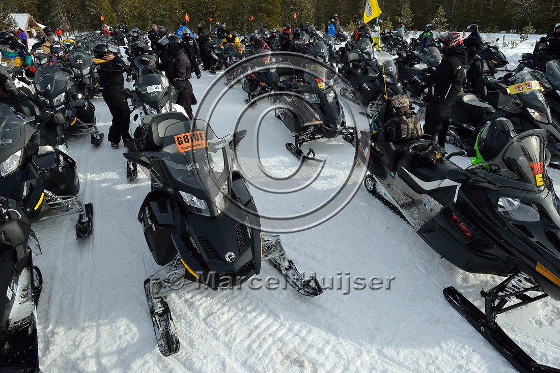 Lines of snowmobiles at Madison junction parking area, Yellowstone National Park, Wyoming, USA