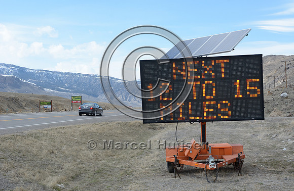 Wildlife warning sign, variable message sign, wildlife on roadway, reduce speed 55 MPH, next 12 to 15 miles, Montana. USA