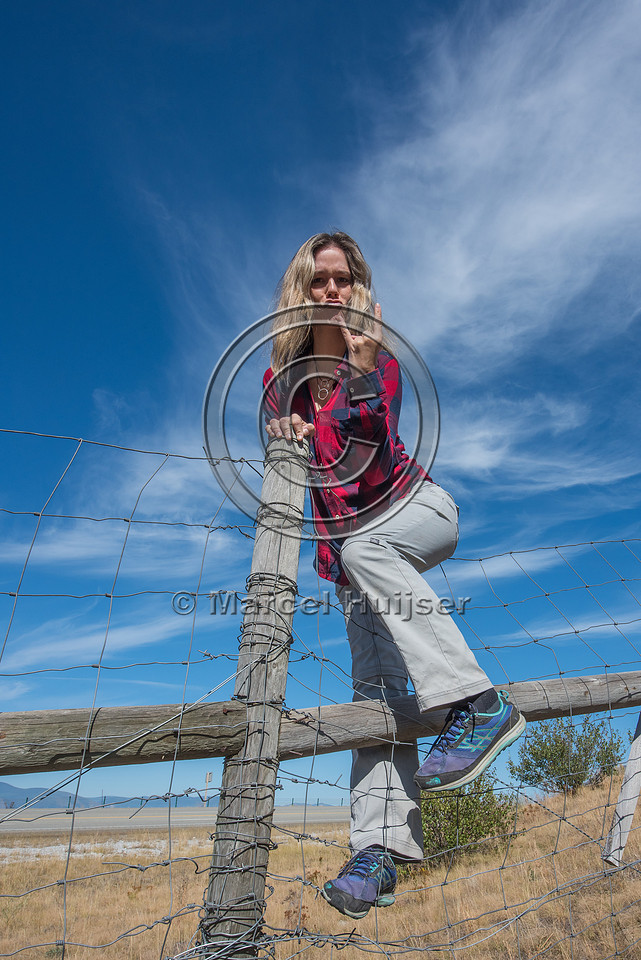 Fernanda Abra climbing a wildlife fence, north of Bonners Ferry,