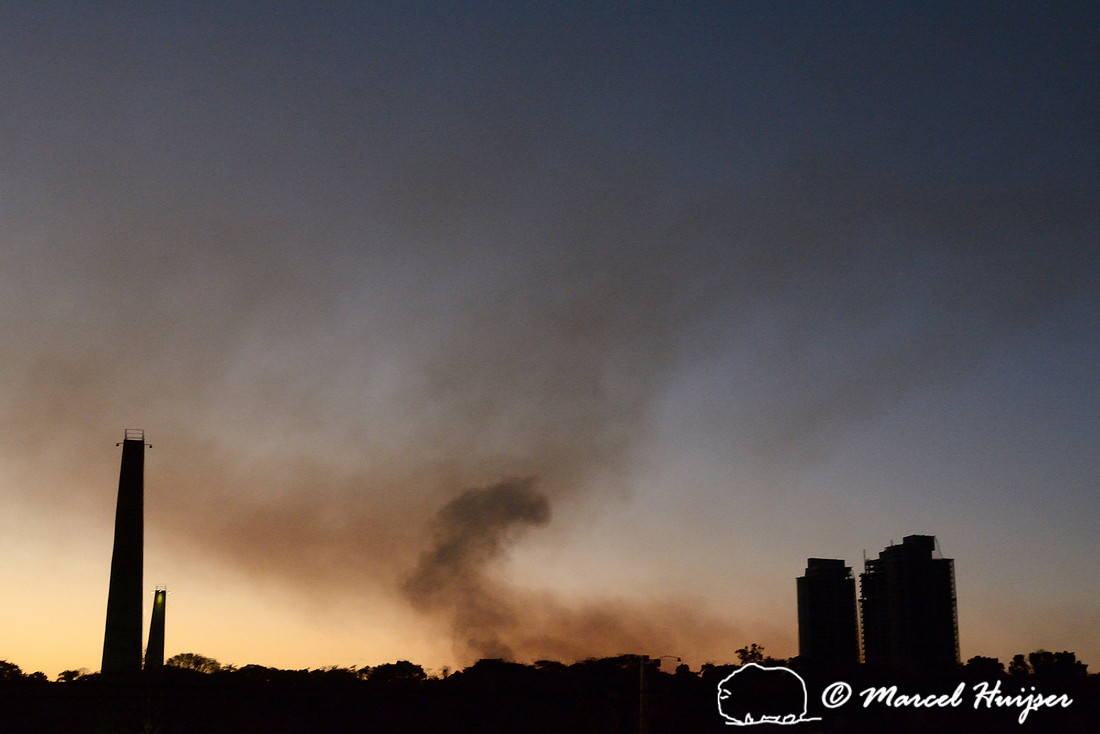 Evening skyline of Piracicaba with smoke from burning sugar cane fields, São Paulo State, Brazil