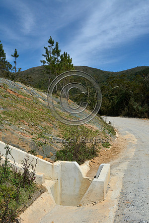 Concrete drainage gutter (left) to capture water seeping from the cut slope, and entrance to drainage culvert, Parque Nacional da Serra da Bocaina, São Paulo, Brazil