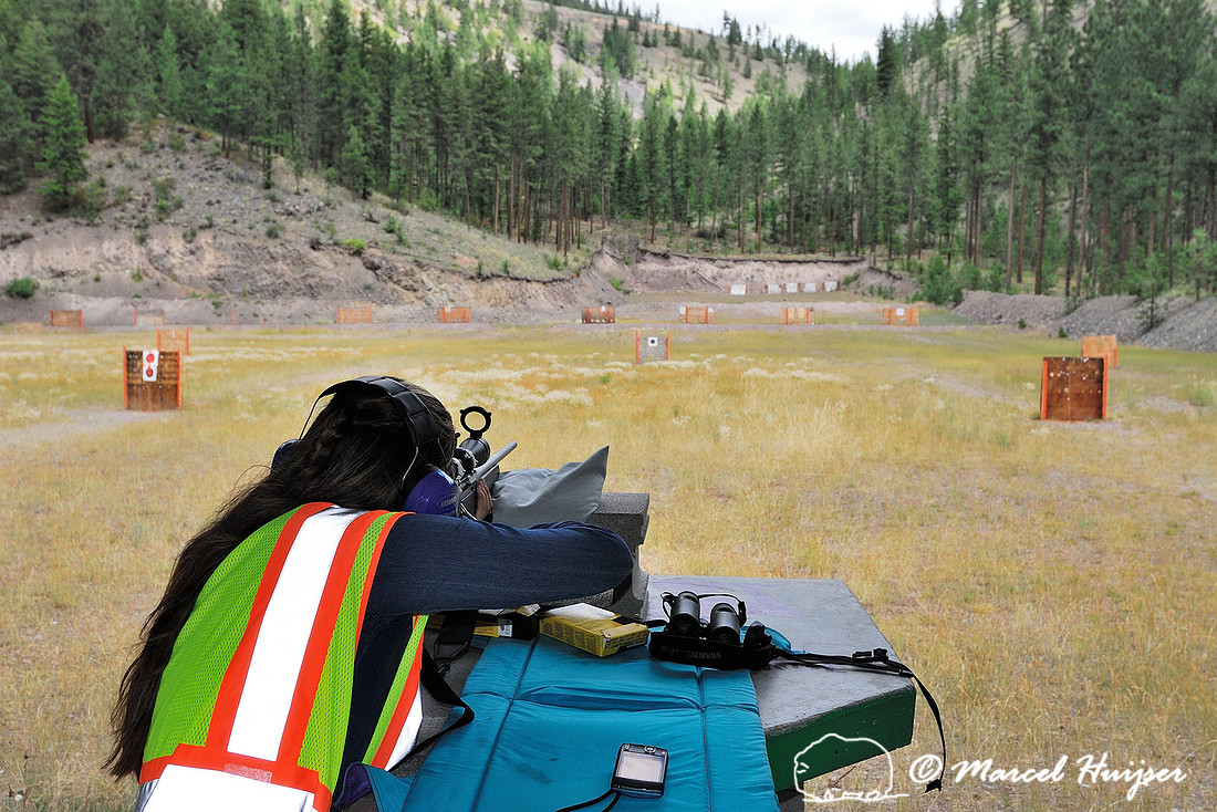 Woman shooting gun at shooting range, Montana, USA