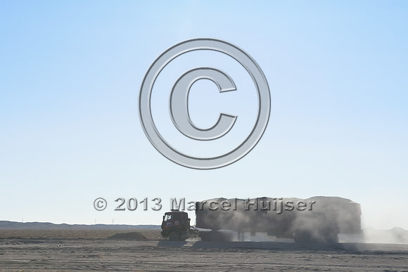 Coal trucks hauling coal to the border and dust, between Tsagaan khad (White Rock) and Gashuun-Sukhait, Gobi, Mongolia