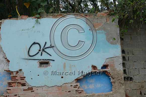 OK sign indicates the property in the favela (slums) has been purchased and can be demolished to make way for the new motorway, Greater São Paulo, Brazil