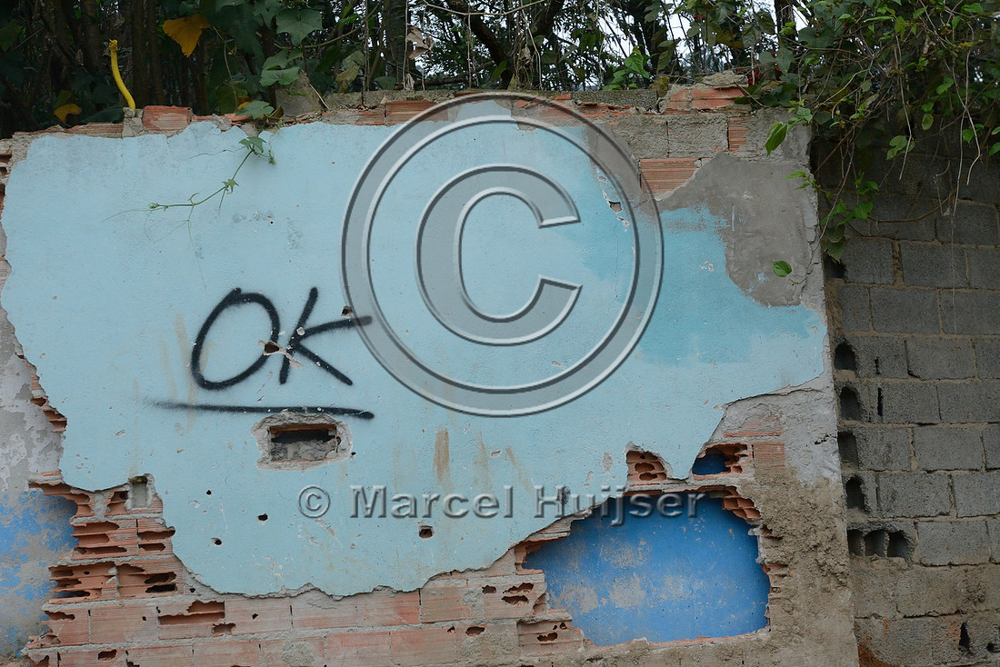 OK sign indicates the property in the favela (slums) has been purchased and can be demolished to make way for the new motorway, Greater São Paulo, Brazil