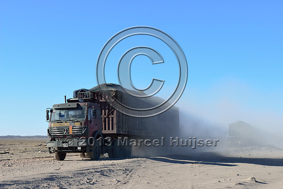 Coal trucks hauling coal to the border and dust, between Tsagaan khad (White Rock) and Gashuun-Sukhait, Gobi, Mongolia