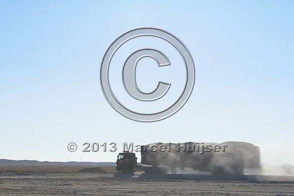 Coal trucks hauling coal to the border and dust, between Tsagaan khad (White Rock) and Gashuun-Sukhait, Gobi, Mongolia