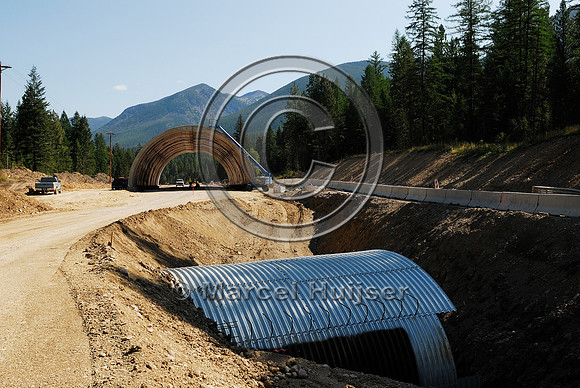 Wildlife overpass  "animals' bridge" and a wildlife underpass under construction, US Hwy 93, Flathead Indian Reservation, near Evaro, Montana, USA