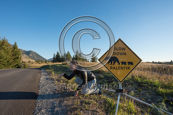 Fernanda Abra at wildlife warning sign for bears, Alberta, Canad