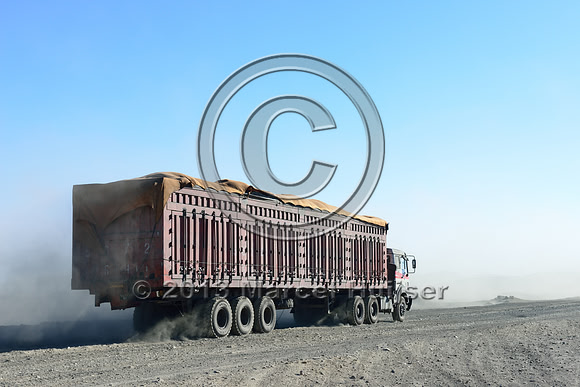 Coal trucks departing the settlement of Tsagaan khad (White Rock), north of Gashuun-Sukhait, Gobi, Mongolia