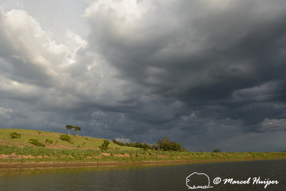 Thunderstorm with dark clouds over Tanqua wetland, Piracicaba river, São Paulo, Brazil