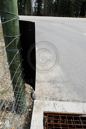 Rubber strips at a wildlife guard installed to make it more difficult for deer (Odocoileus spp.) to walk across the concrete ledge and access the highway, near Stevensville, Montana, USA
