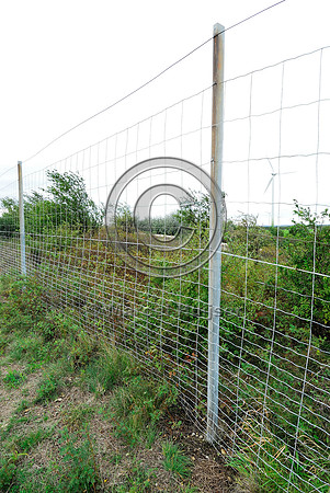 Mesh wire wildlife fence with metal poles on top of multifunctional overpass (wildlife, bicyclists, pedestrians; about 100 m wide), across A4 motorway, Parndorf, Austria