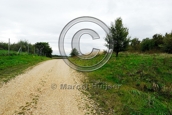 Gravel road on top of multifunctional overpass (wildlife and farm road, about 100 m wide), across A4 motorway, Parndorf, Austria