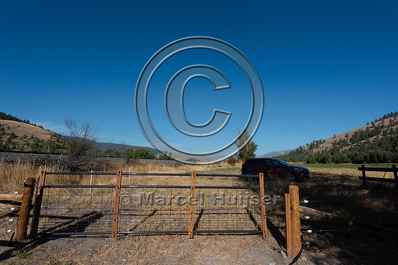 Installing electric fence and gates at a melon field to keep bla