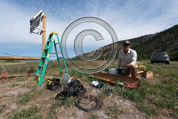 Installing electric fence and gates at a melon field to keep bla