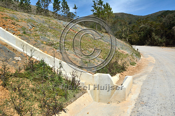 Concrete drainage gutter (left) to capture water seeping from the cut slope, and entrance to drainage culvert, Parque Nacional da Serra da Bocaina, São Paulo, Brazil
