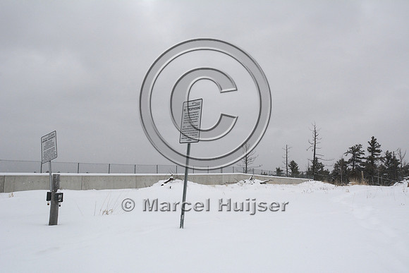 No tresspassing sign and wildlife cameras at wildlife overpass, Hwy 69, Ontario, Canada